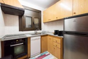 a kitchen with a stainless steel refrigerator and a sink at Pis al centre de Canillo, a prop del telecabina HUT 8304 in Canillo