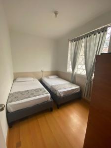 Postel nebo postele na pokoji v ubytování Hostal Casa Primavera