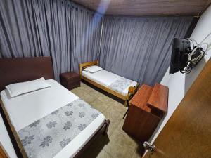 Postel nebo postele na pokoji v ubytování Hostal Casa Primavera