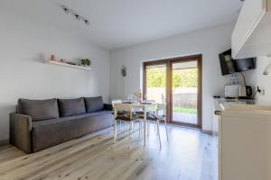 a living room with a couch and a table at PlumTree Holiday Apartment in Gdańsk