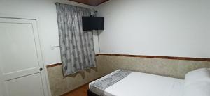 Postel nebo postele na pokoji v ubytování Hostal Casa Primavera