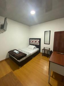 Postel nebo postele na pokoji v ubytování Hostal Casa Primavera