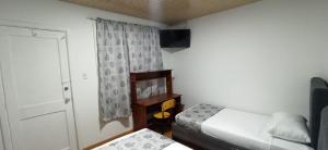 Postel nebo postele na pokoji v ubytování Hostal Casa Primavera