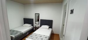 Postel nebo postele na pokoji v ubytování Hostal Casa Primavera
