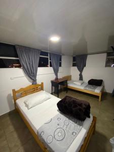 Postel nebo postele na pokoji v ubytování Hostal Casa Primavera