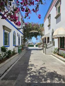 an empty street in a town with white buildings at Teresita "La Fuente" - Puerto de Mogan in Puerto de Mogán