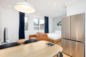 a kitchen and living room with a table and a refrigerator at Les Lofts de Vitré - Par Les Lofts Vieux-Québec in Quebec City