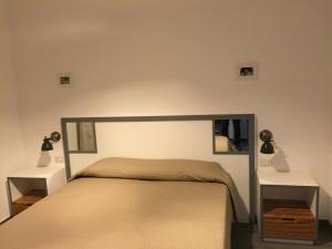 a bedroom with a large bed with two night stands at B&B Casa Dolce Luna in Cosenza