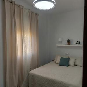 Posteľ alebo postele v izbe v ubytovaní Ático Vacacional Manzanilla