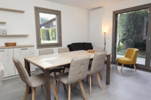 a kitchen and dining room with a wooden table and chairs at Résidence Hameau Des Reines - Hameau des Reines MAE-9981 in Servoz