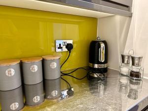 a kitchen with a counter top with a coffee maker at Cute Studio Basement Flat Richmond in Richmond upon Thames