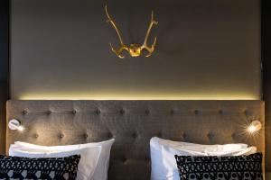 
a bed that has a lamp on top of it at Lapland Hotels Oulu in Oulu
