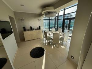 a kitchen and dining room with a table and chairs at Marque De Lago in Bucharest