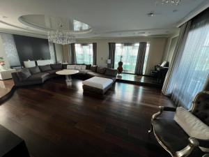 a living room filled with furniture and a chandelier at Marque De Lago in Bucharest