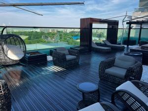 a deck with chairs and a pool on a building at Marque De Lago in Bucharest
