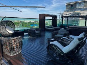 a deck with chairs and tables on a building at Marque De Lago in Bucharest
