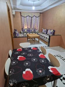 a dining room with a table and chairs in a room at Logement climatisé proche de Fès in El Harmiine +16 photos