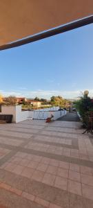 a view of a patio with a table and benches at Casa vacanza 70 mq in Valledoria