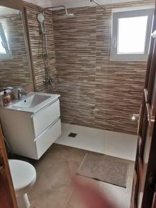 a bathroom with a sink and a toilet and a window at Los Cactus in Santa Cruz de Tenerife