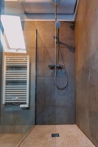 a bathroom with a shower with a glass door at Charmant appartement proche DisneyLand in Bussy-Saint-Georges