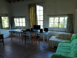 a living room with a table with two computers on it at Mas Ferrieres Saint Laurent sud in Saint-Laurent-le-Minier