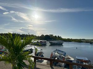 a group of boats are docked in a harbor at Mar à Vista Boipeba Frente Mar by LVF in Ilha de Boipeba