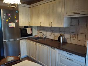 a kitchen with white cabinets and a counter top at Green Hous agroturystyka in Pelnik