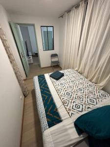 a bedroom with a bed and a chair in it at M2 Appart 3 chambres 5 min metro - PARC EXPO in Malakoff