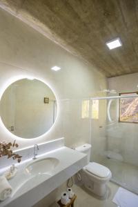 a bathroom with a sink and a toilet and a mirror at Pousada Altoé da Montanha in Venda Nova do Imigrante +71 photos