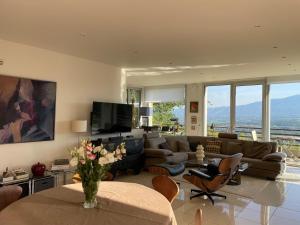 a living room with a couch and a table at La Beaume in Blauvac