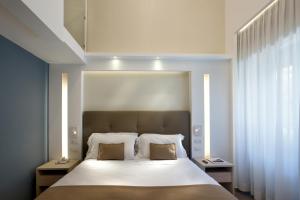 a bedroom with a large bed with two pillows at Montespina Park Hotel in Naples +37 photos