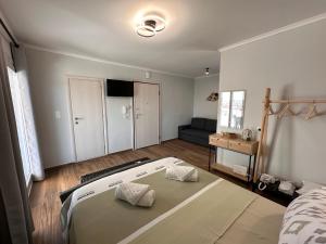 a bedroom with a bed and a couch in it at Vista Kavala Center in Kavála +102 photos
