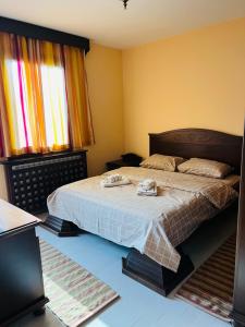 a bedroom with a bed with two towels on it at Vila Milena in Žabljak
