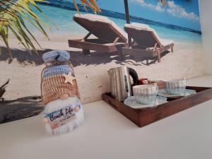 a table with a tray of food and two chairs on the beach at Sunny Waves in Northampton