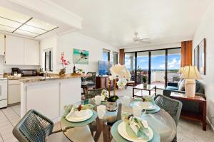 a kitchen and living room with a table and chairs at Kapalua Golf Villa 23T 4&5 in Kahana