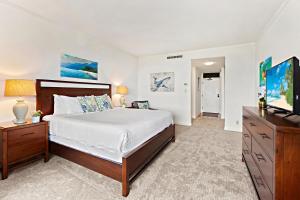 a bedroom with a bed and a flat screen tv at Kapalua Golf Villa 23T 4&5 in Kahana +34 photos