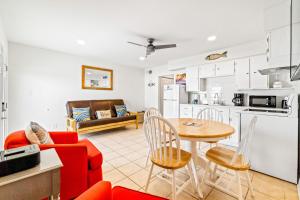 a kitchen and living room with a table and chairs at Moonraker 25 in Gulf Shores