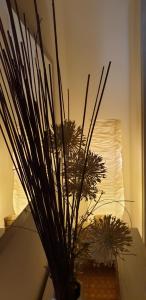 a vase with some plants in it on a table at La Casa di Oli&Cris in Bolsena