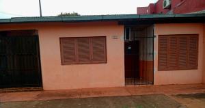 a building with two doors and a fence at Casa Marconi in Posadas +3 photos