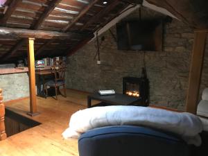 a living room with a couch and a fireplace at Casa Milu in Armiello