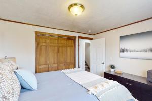 a bedroom with a large bed with a wooden door at Peaceful Palace in Parowan in Parowan