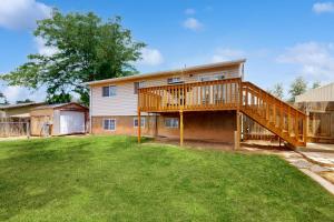 a large house with a deck and a yard at Peaceful Palace in Parowan in Parowan