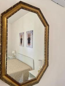 a mirror on a wall with a bed in a room at Loriano Apartment in Capaci +19 photos
