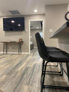 a black chair in a living room with a table at Apt 4 - High Plains Lodge at Nomad Landing in Clayton +9 photos