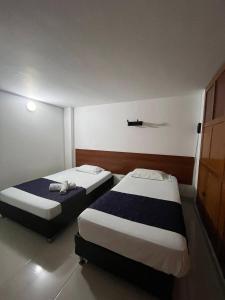 Voodi või voodid majutusasutuse HOTEl OTUN PLAZA PEREIRA toas