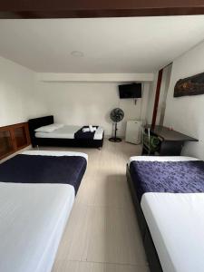 Voodi või voodid majutusasutuse HOTEl OTUN PLAZA PEREIRA toas