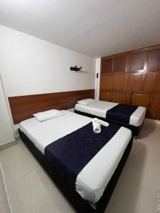Voodi või voodid majutusasutuse HOTEl OTUN PLAZA PEREIRA toas