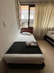 Voodi või voodid majutusasutuse HOTEl OTUN PLAZA PEREIRA toas