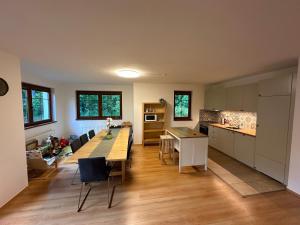 a kitchen with a long table and chairs in a room at Villa Park Lipno 208 in Lipno nad Vltavou