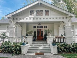 a white house with a welcoming front door at Guesthouse on Girod in Mandeville